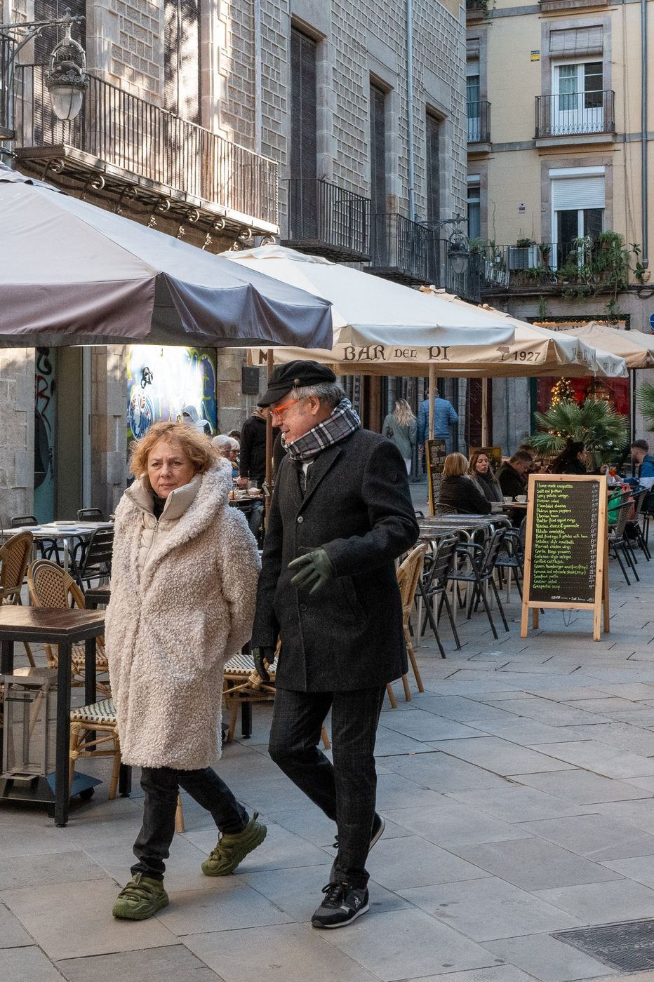 Couple walking down a shopping street, Barcelona