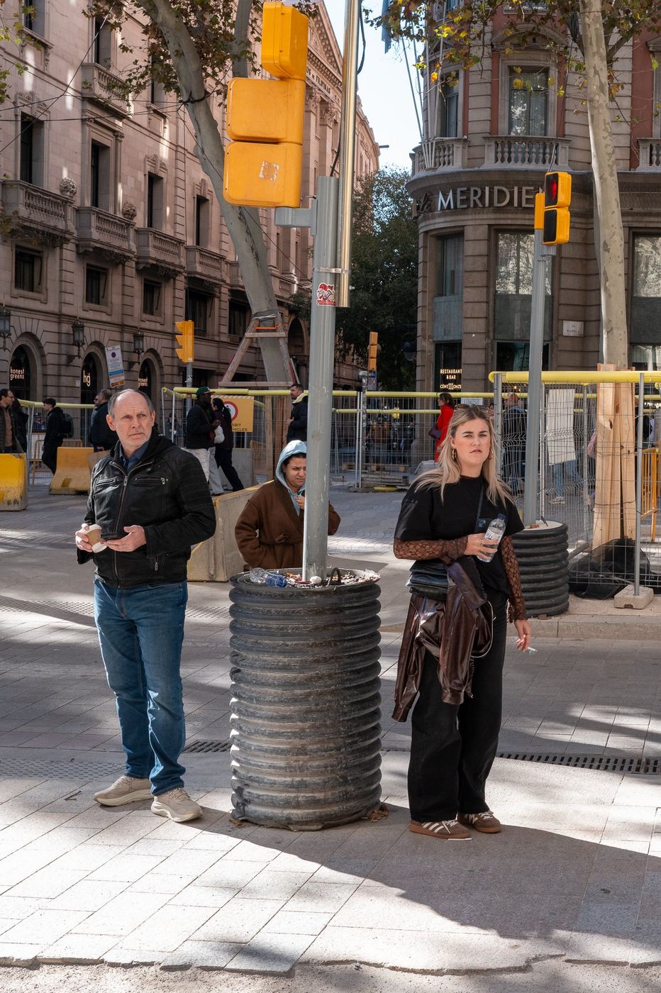 Passerby waiting near a public trash can, Barcelona