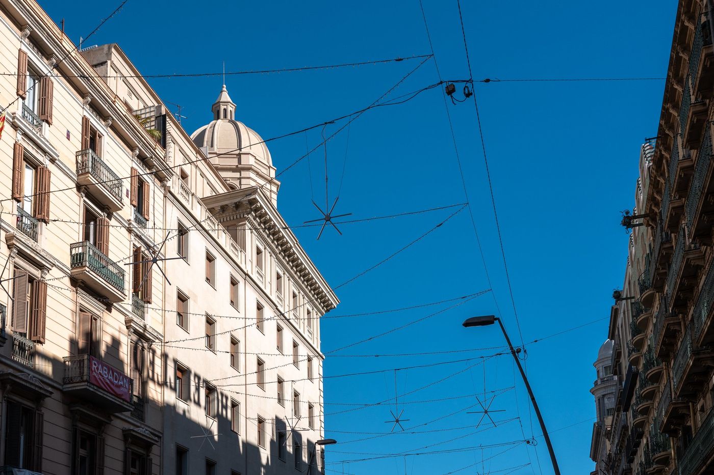 Tower and tramway lines under a blue sky, Barcelona