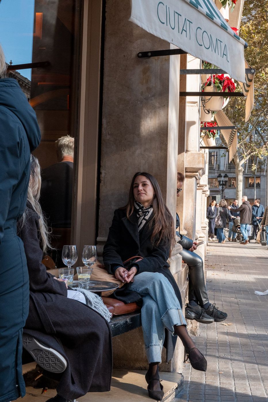 Two people sitting on a bench in a street, Barcelona