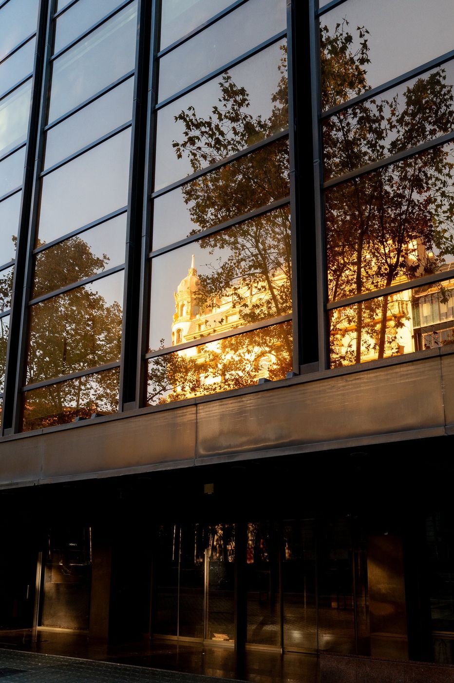 Reflections in a lit shop window at night, Barcelona