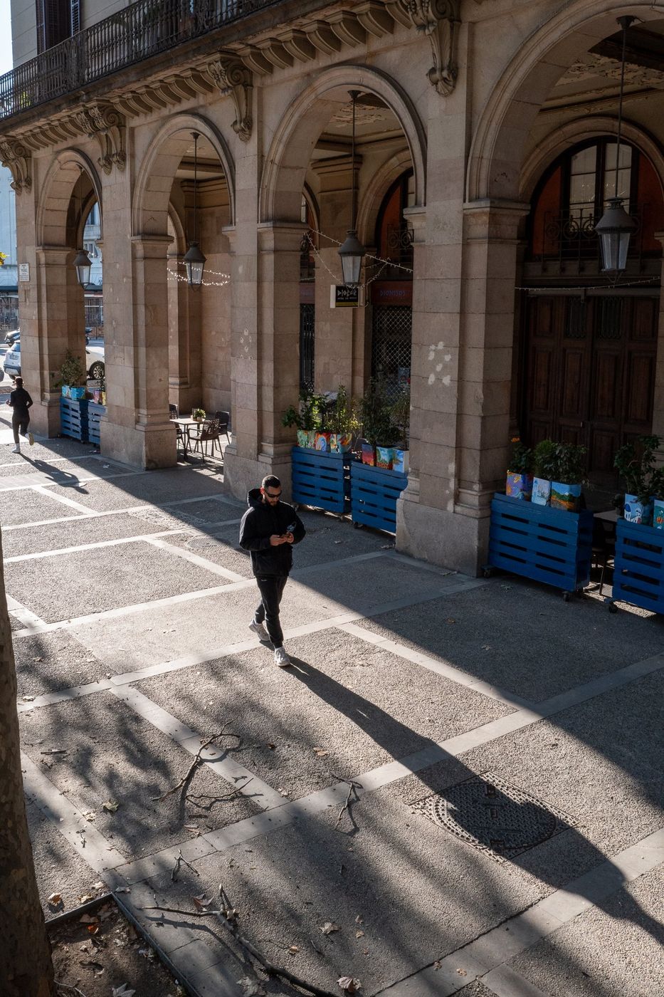 Passerby crossing a street, backlit, Barcelona