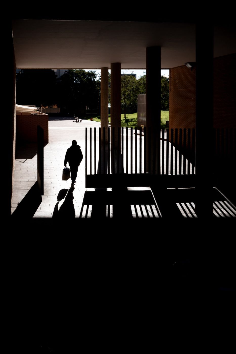 Solitary silhouette through a grille, backlit, Barcelona