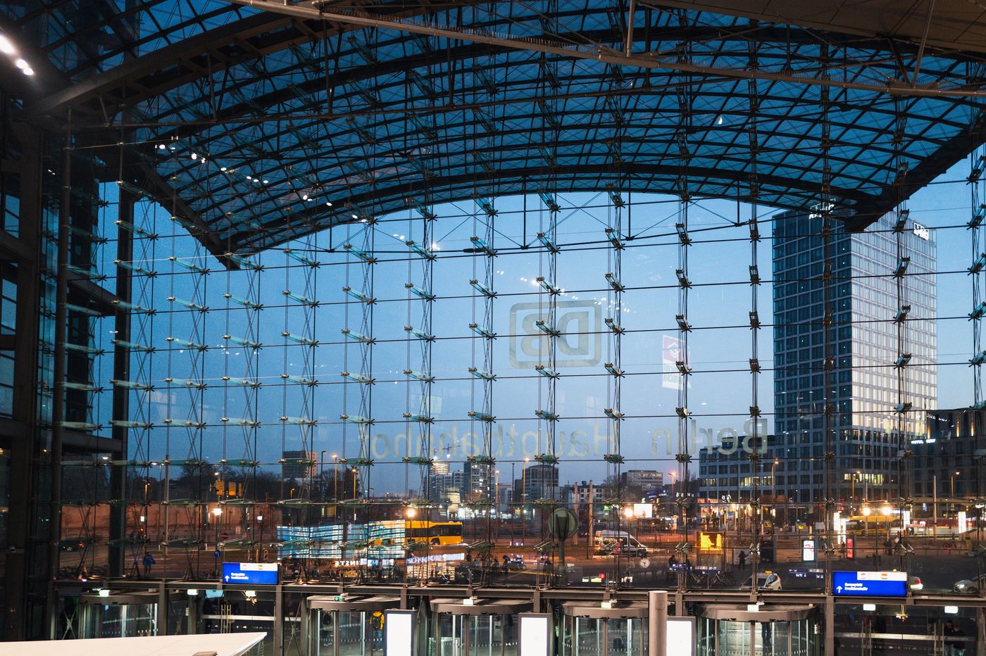 Curved glass roof of the central station reflecting the city at dusk, Berlin