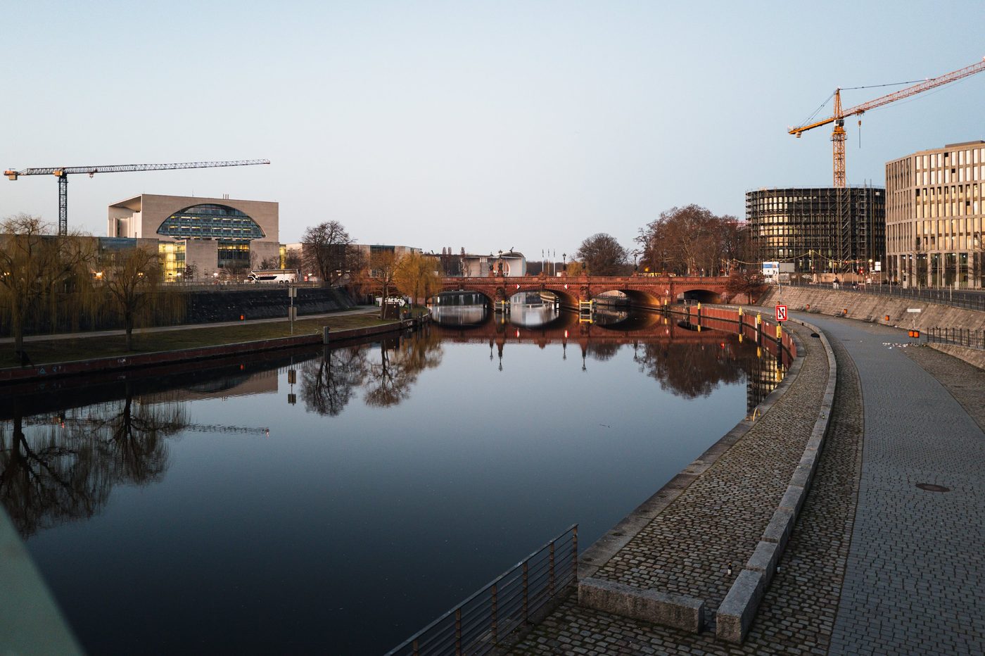 The Spree reflecting the federal chancellery and construction cranes, Berlin
