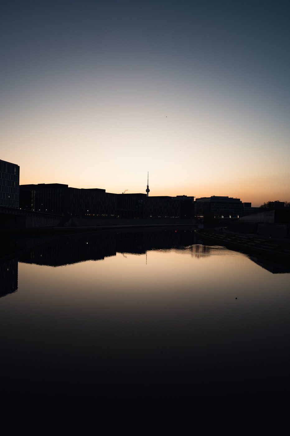 Urban skyline and television tower at sunset over the Spree, Berlin