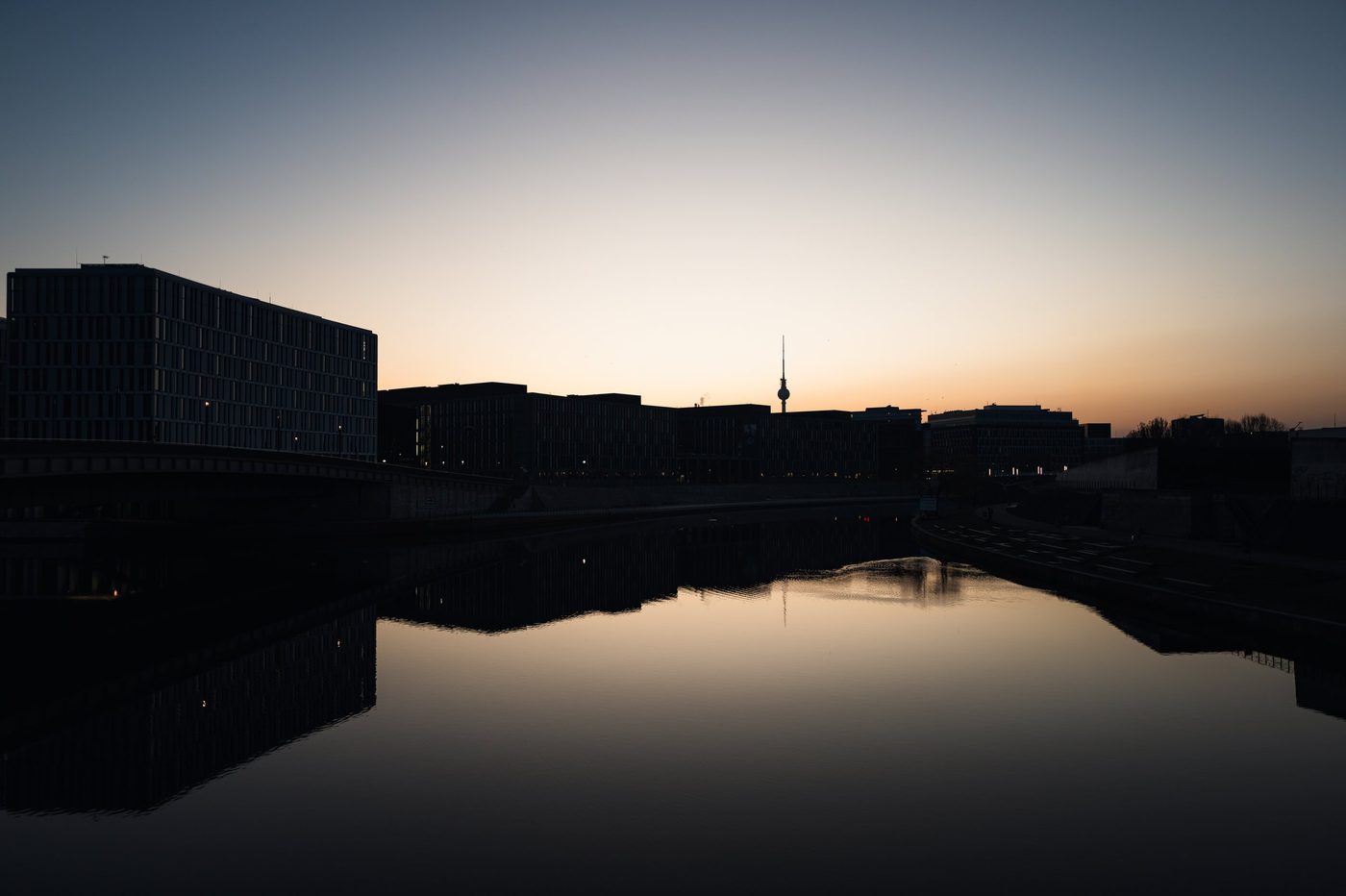 Row of government buildings silhouetted against an orange sky, Berlin