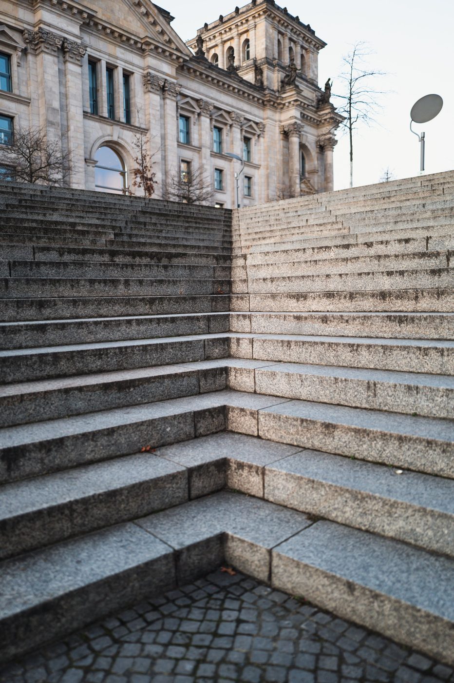 Fan-shaped staircase leading toward the classical facade of the Reichstag, Berlin