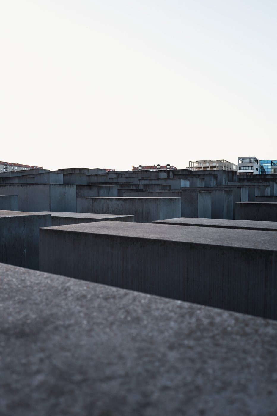 Field of concrete slabs at the Holocaust memorial rising above the rooftops, Berlin