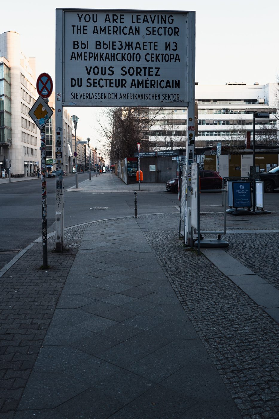 Multilingual sign announcing the exit from the American sector, Checkpoint Charlie, Berlin