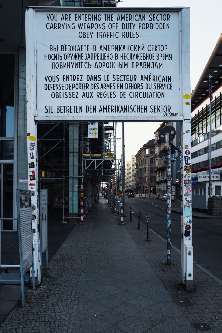 Entry sign into the American sector beneath scaffolding, Checkpoint Charlie, Berlin