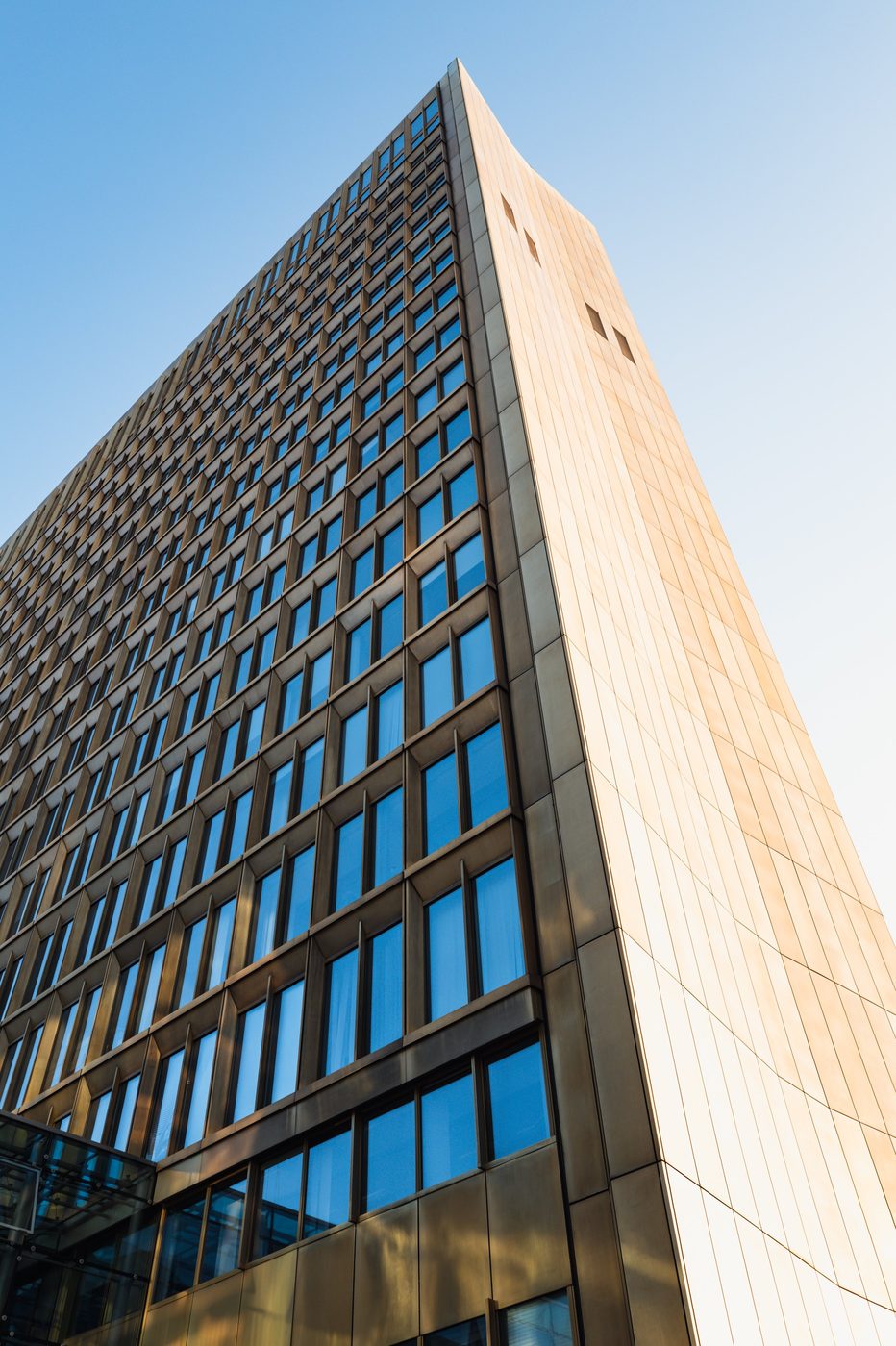 Low-angle view of the golden glass facade of an office tower, Berlin