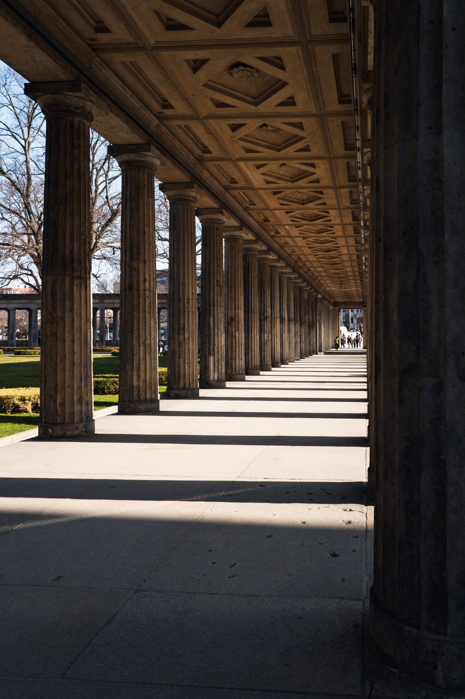 Perspective of classical columns leading toward visitors in the distance, Berlin