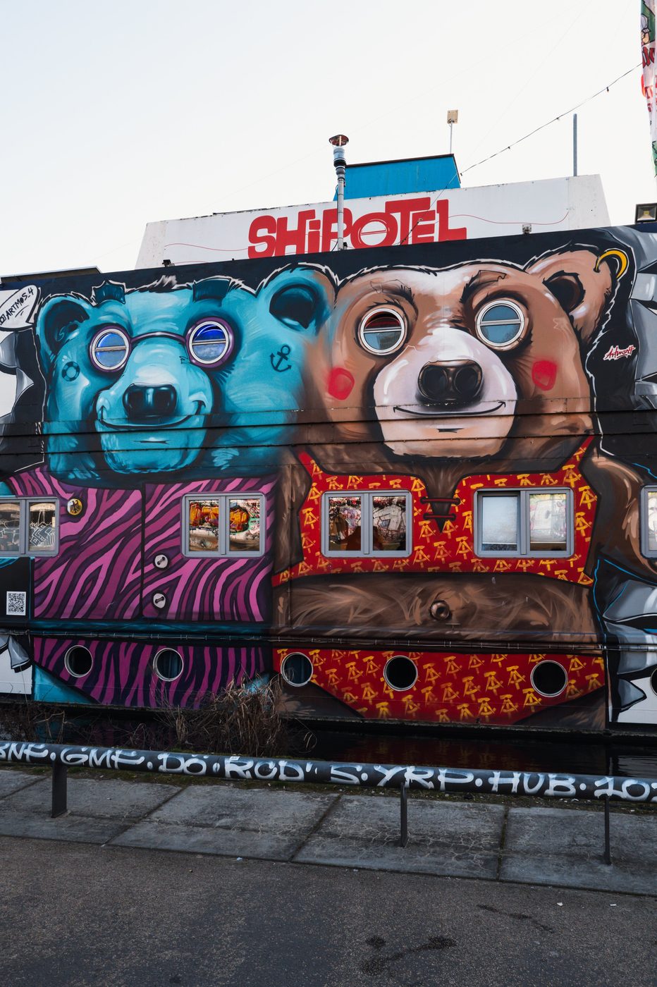 Mural of two bears painted on the colorful facade of the Shipotel, Berlin