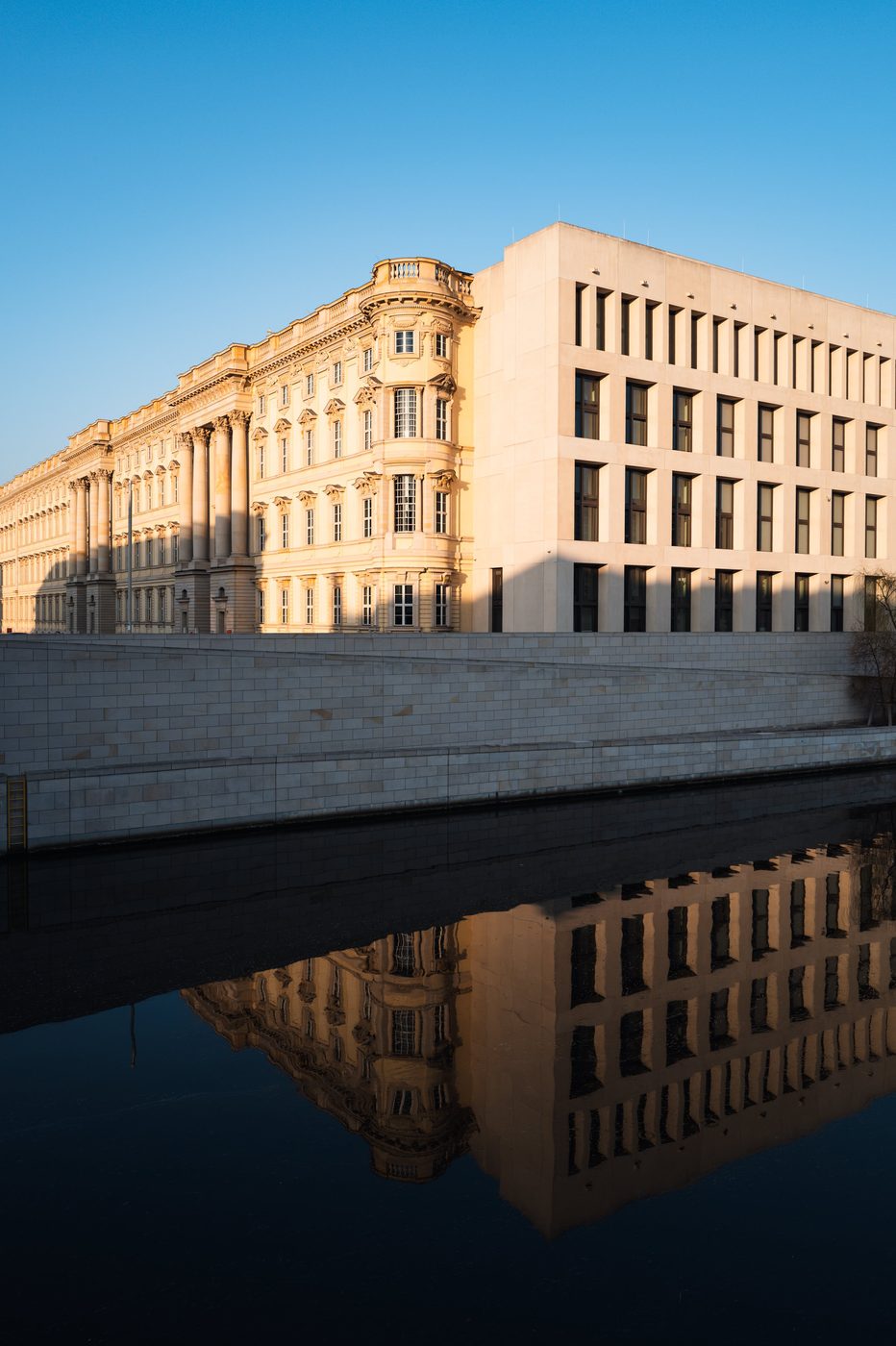 Golden facade of the Berlin Palace reflected in the canal at dusk, Berlin