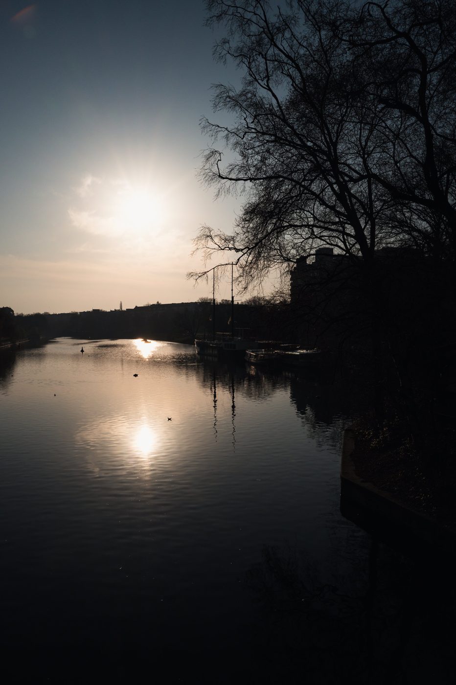 Sunset over the river, silhouettes of moored barges, Berlin