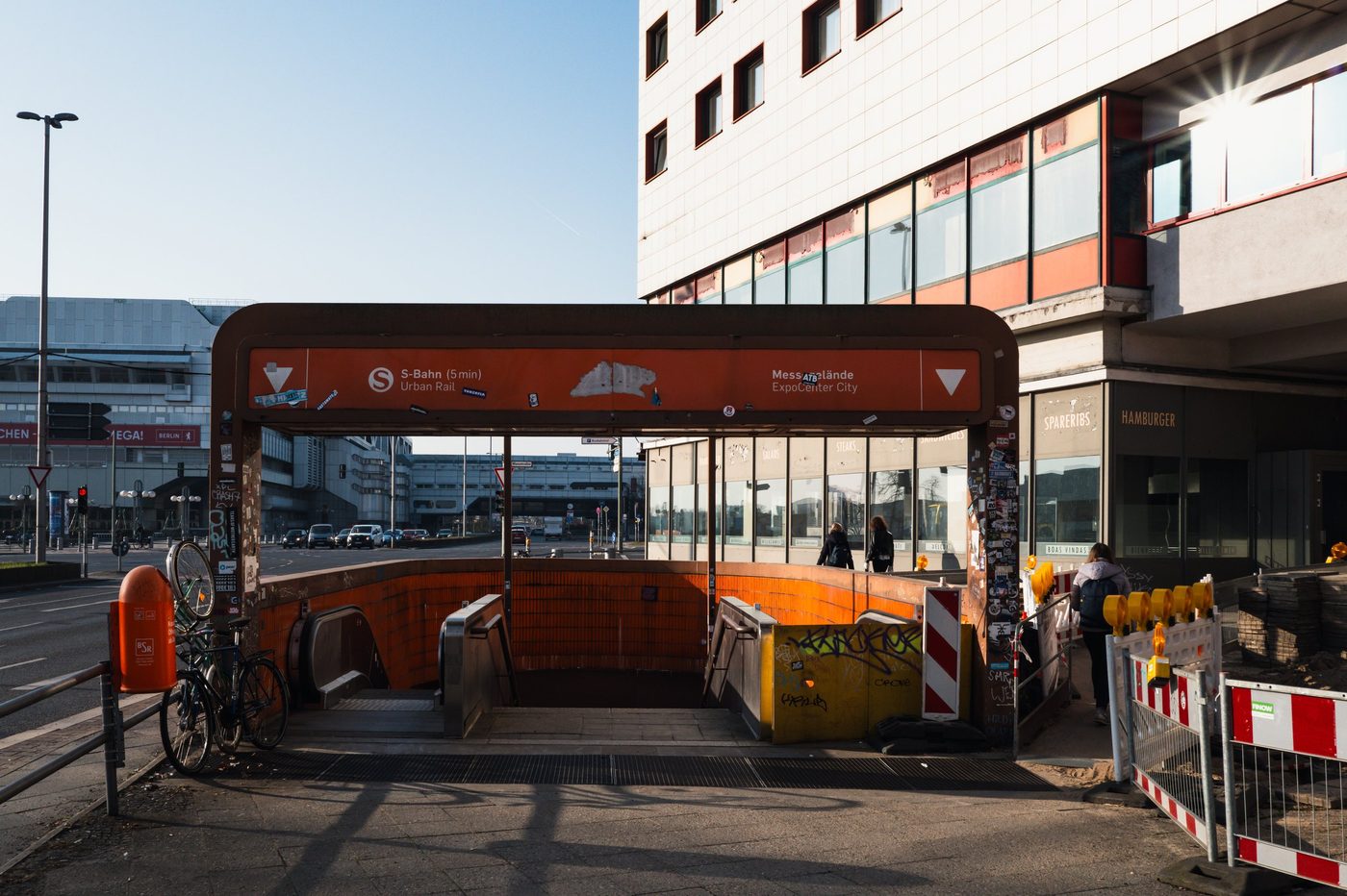 Orange S-Bahn entrance leading toward the trade fair district, Berlin