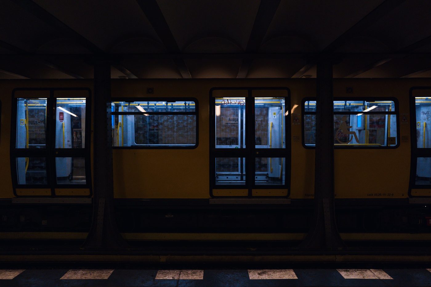 Illuminated doors of a subway train stopped in the dim light, Berlin