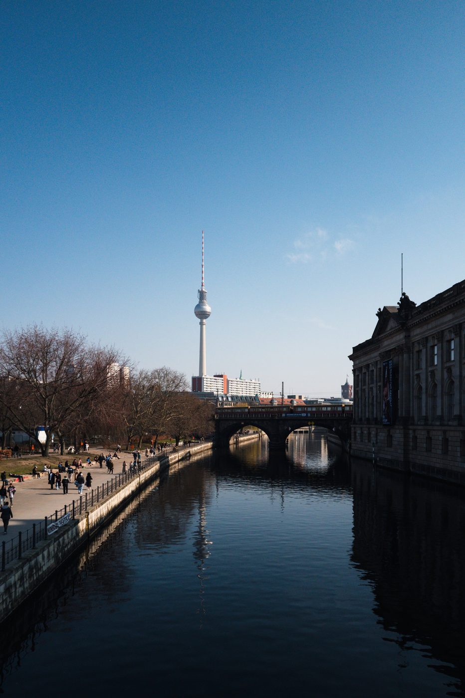 Television tower rising above a bridge and a museum by the Spree, Berlin
