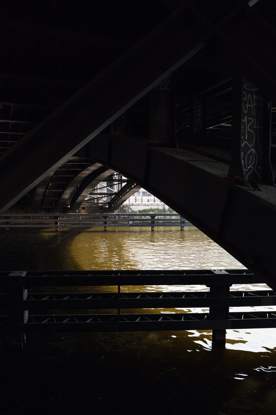 View through the dark metal structure of a bridge over the Spree, Berlin