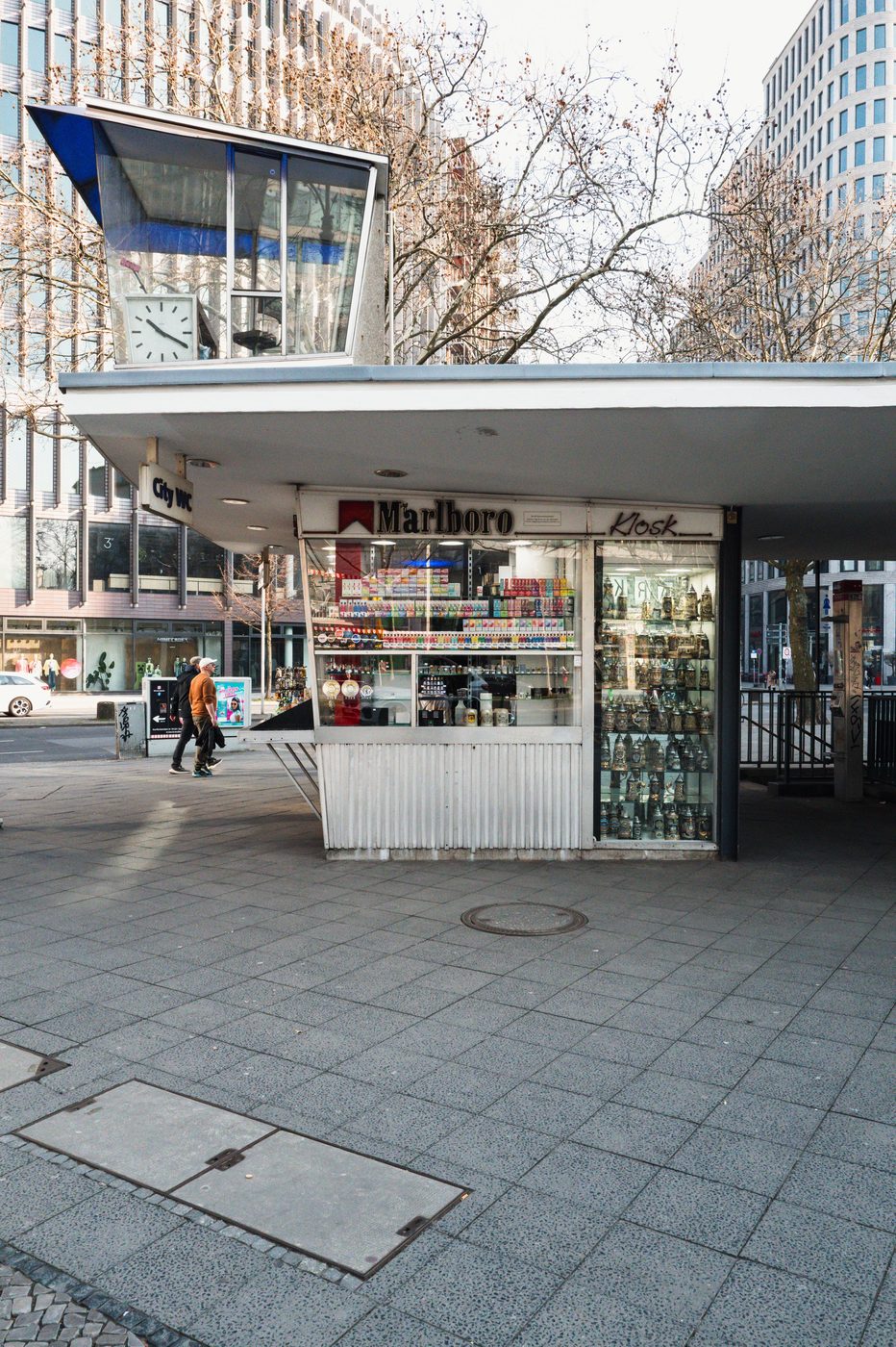 Vintage newspaper kiosk topped with a clock, sixties-era architecture, Berlin