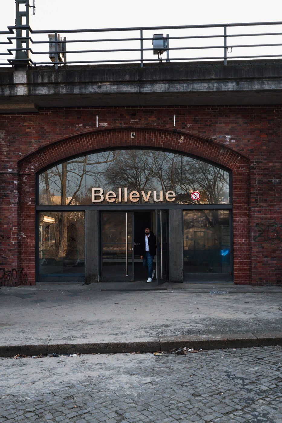 Brick entrance of Bellevue station beneath a railway bridge, Berlin