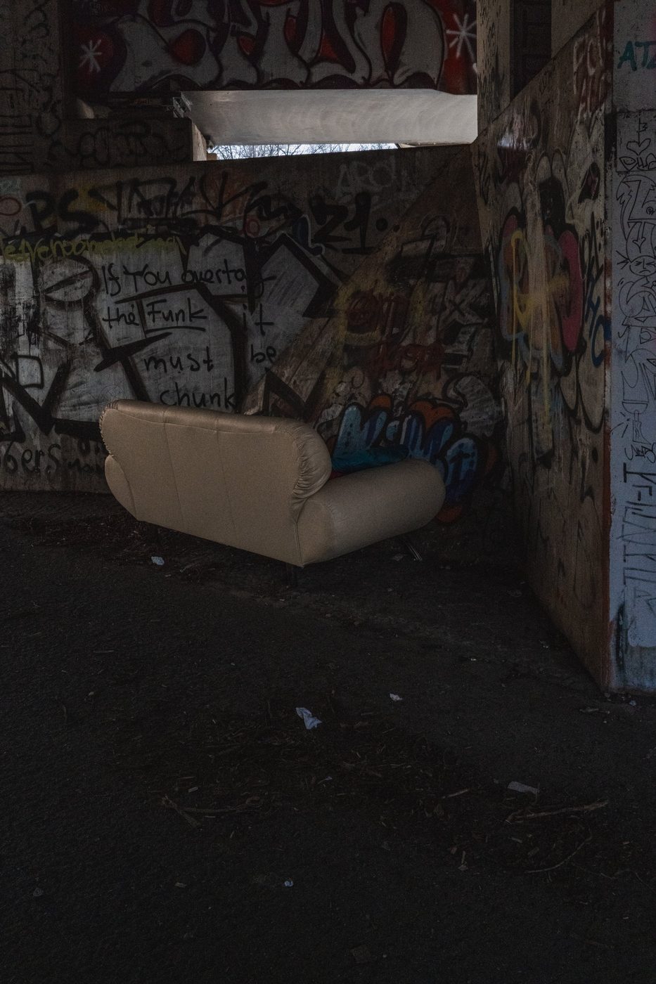 Abandoned sofa in an alcove entirely covered in graffiti, Berlin