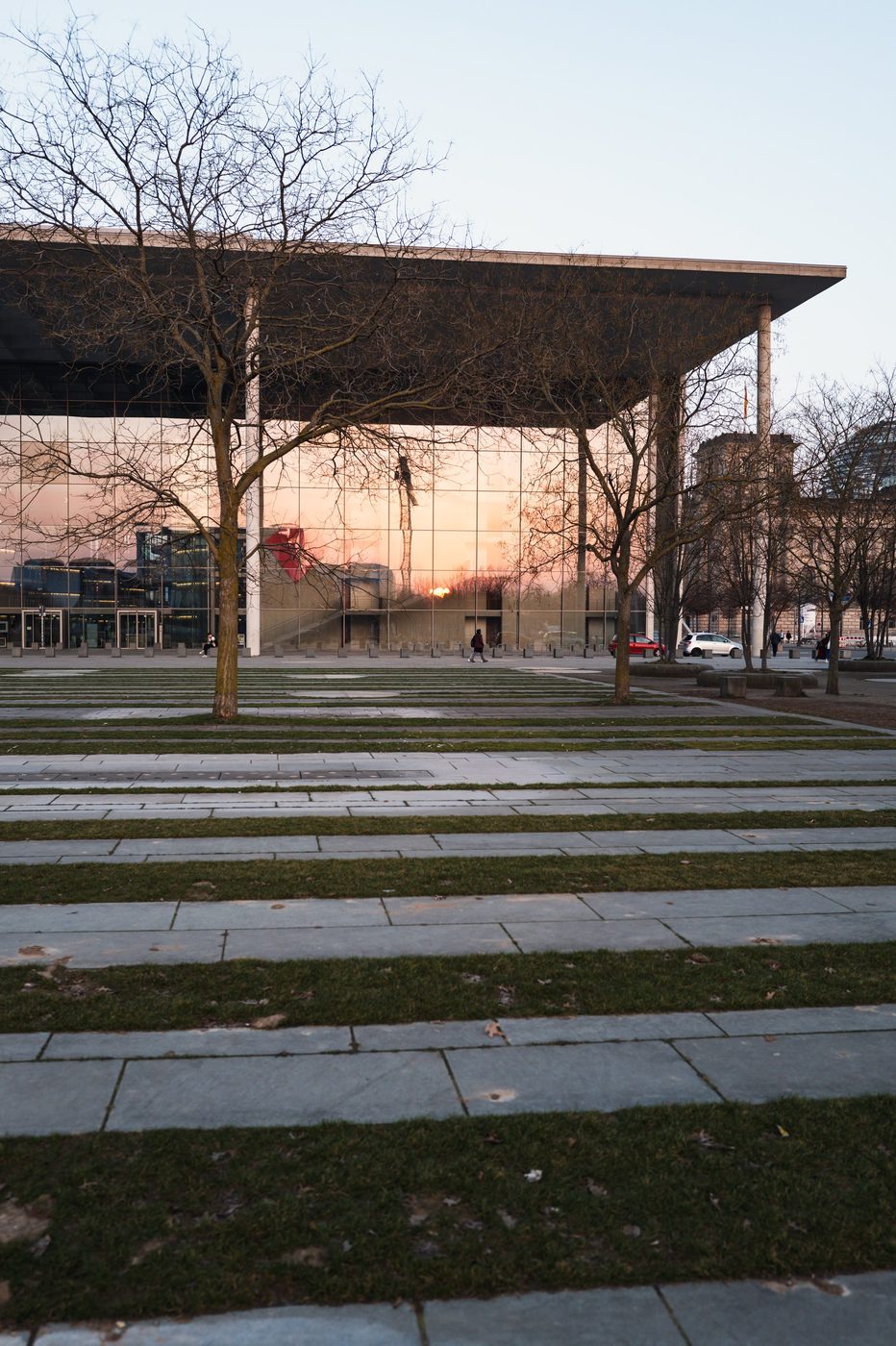 Reflection of a sunset on the glass facade of the Bundestag, lawn in the foreground, Berlin