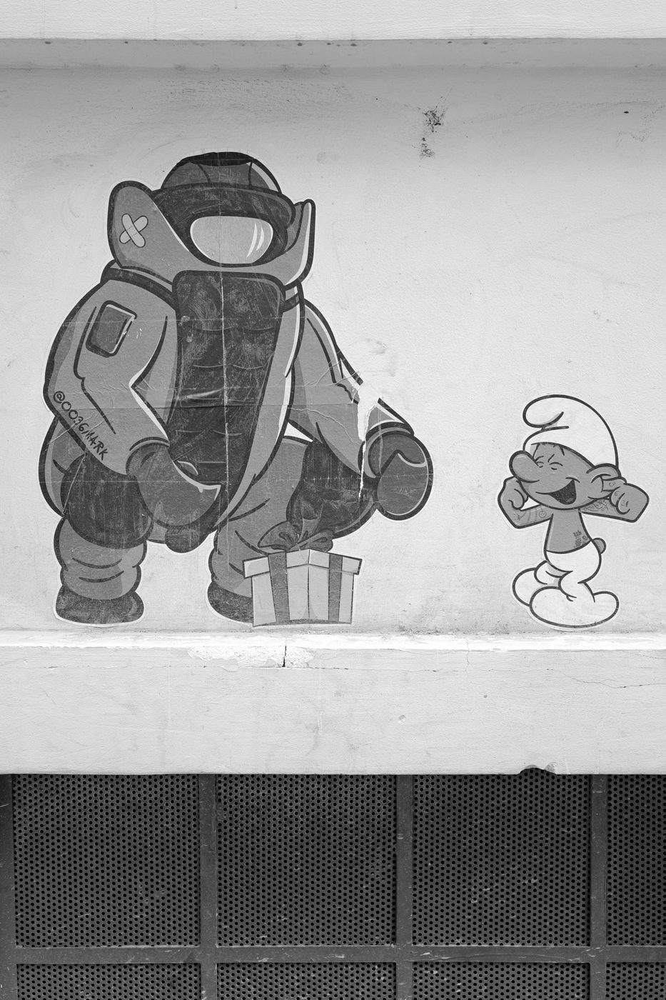 Comic-strip stickers on a wall, bomb-disposal character and a Smurf, Budapest
