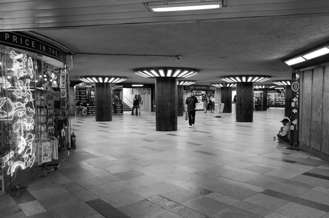 Underpass with circular light ceilings and shops, Budapest