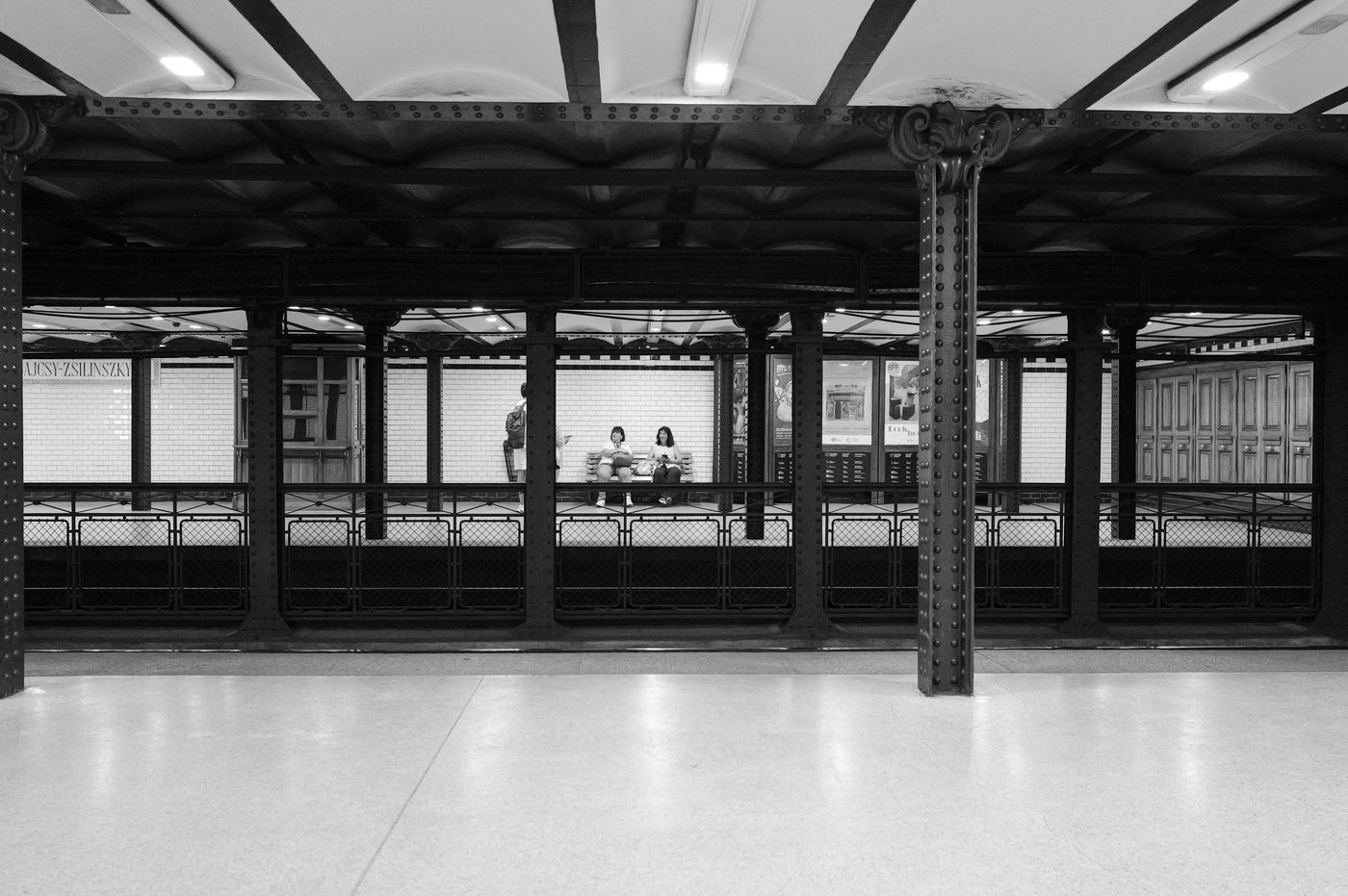 Two passengers waiting on the platform of an old metro station, Budapest