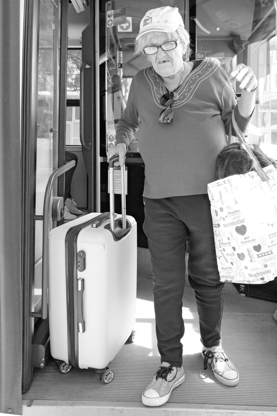 Elderly passenger getting off the bus with her suitcase, Budapest