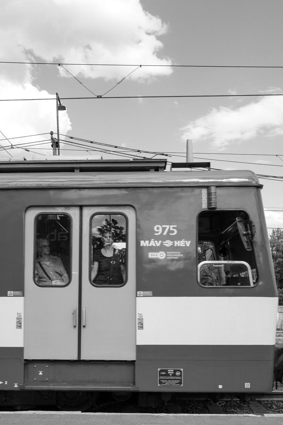 Passengers looking through the windows of a suburban train, Budapest