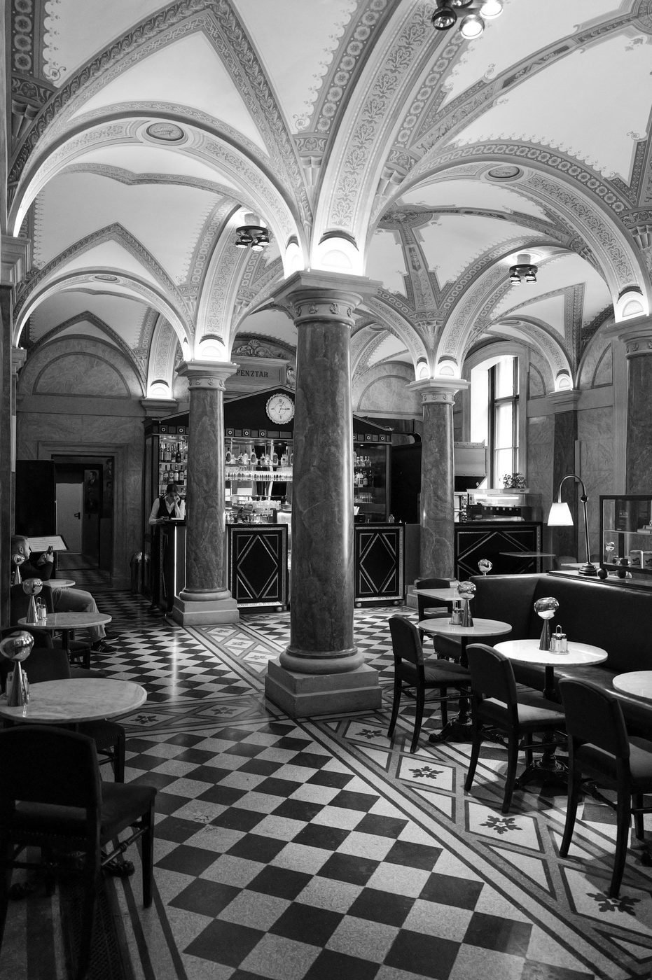 Vaulted café room with marble columns and a chequered floor, Budapest