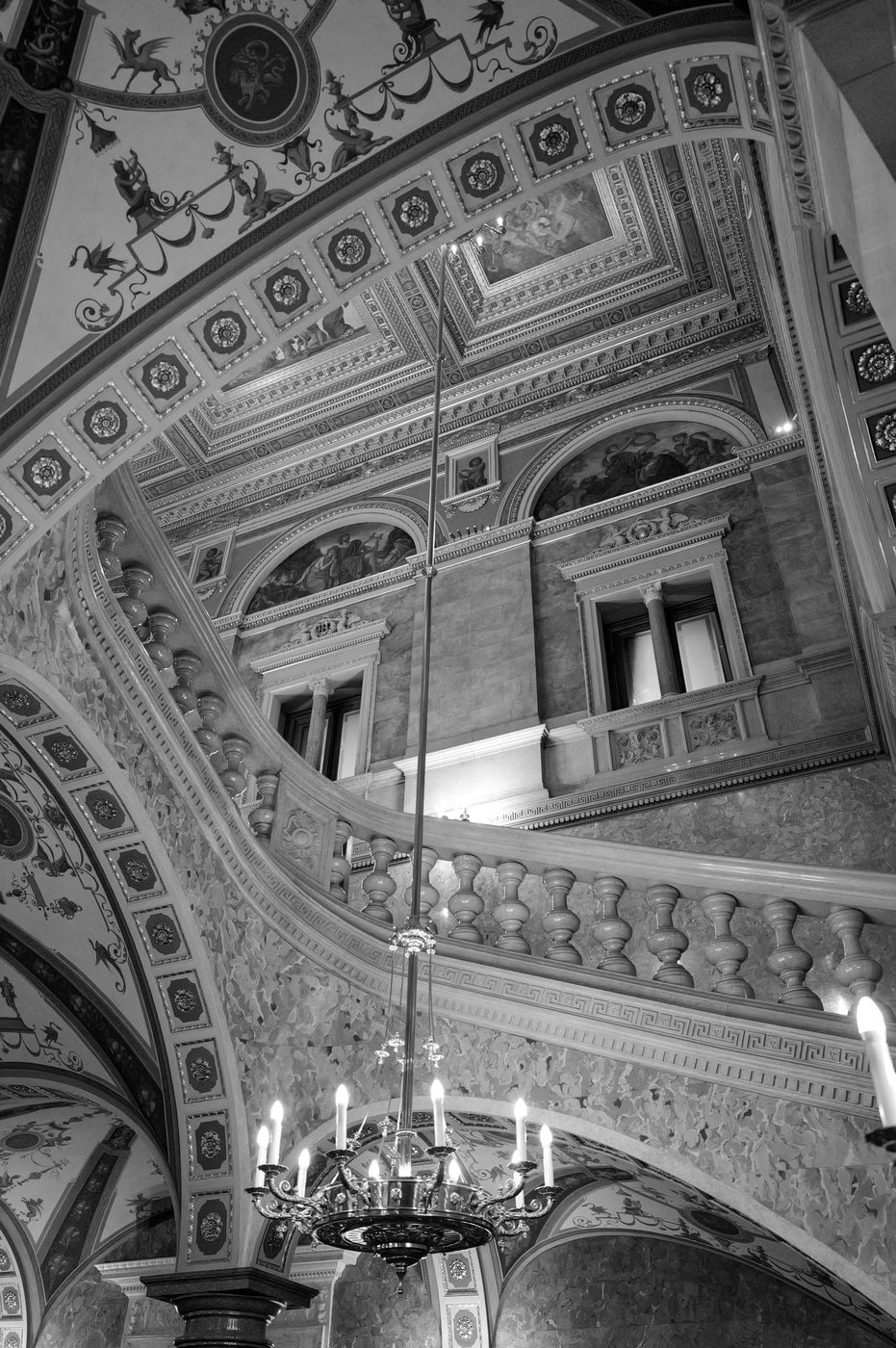 Monumental staircase under a ceiling painted with frescoes and gilding, Budapest