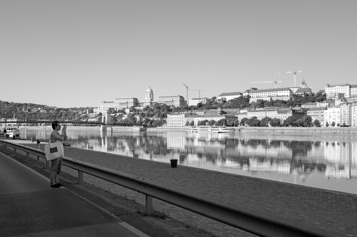 A tourist photographing the Danube facing Buda Castle, Budapest