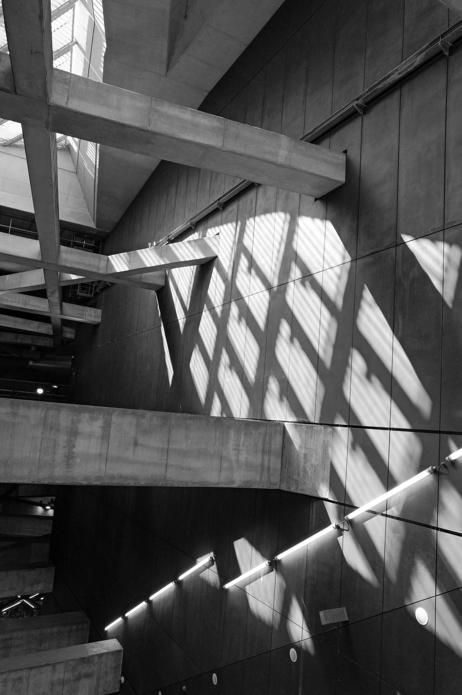 Play of shadows cast by a glass roof on a concrete structure, Budapest