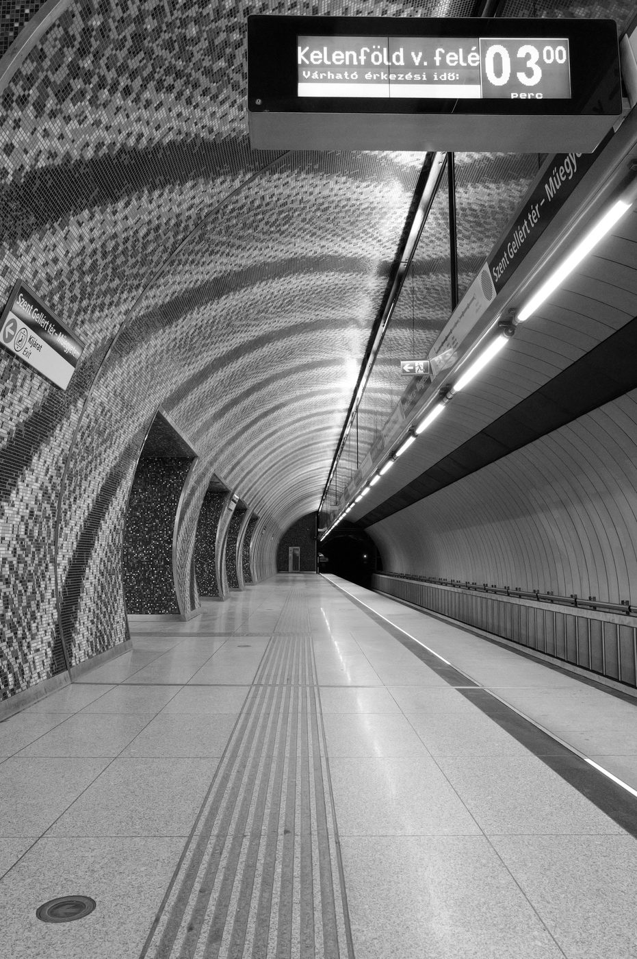 Tubular metro platform with a timetable display board, Budapest
