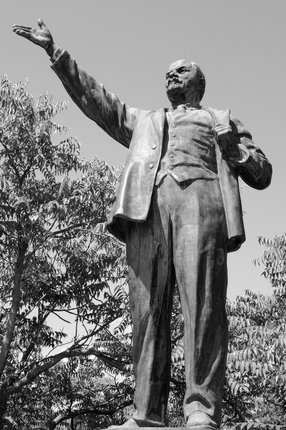 Bronze statue of a Soviet-era leader, arm raised toward the sky, Budapest