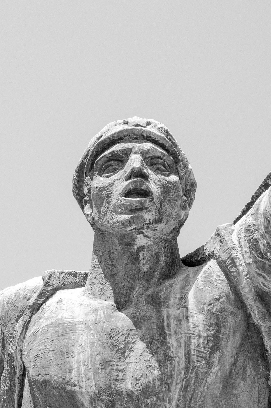 Sculpted face of a heroic statue, gaze raised to the sky, Budapest