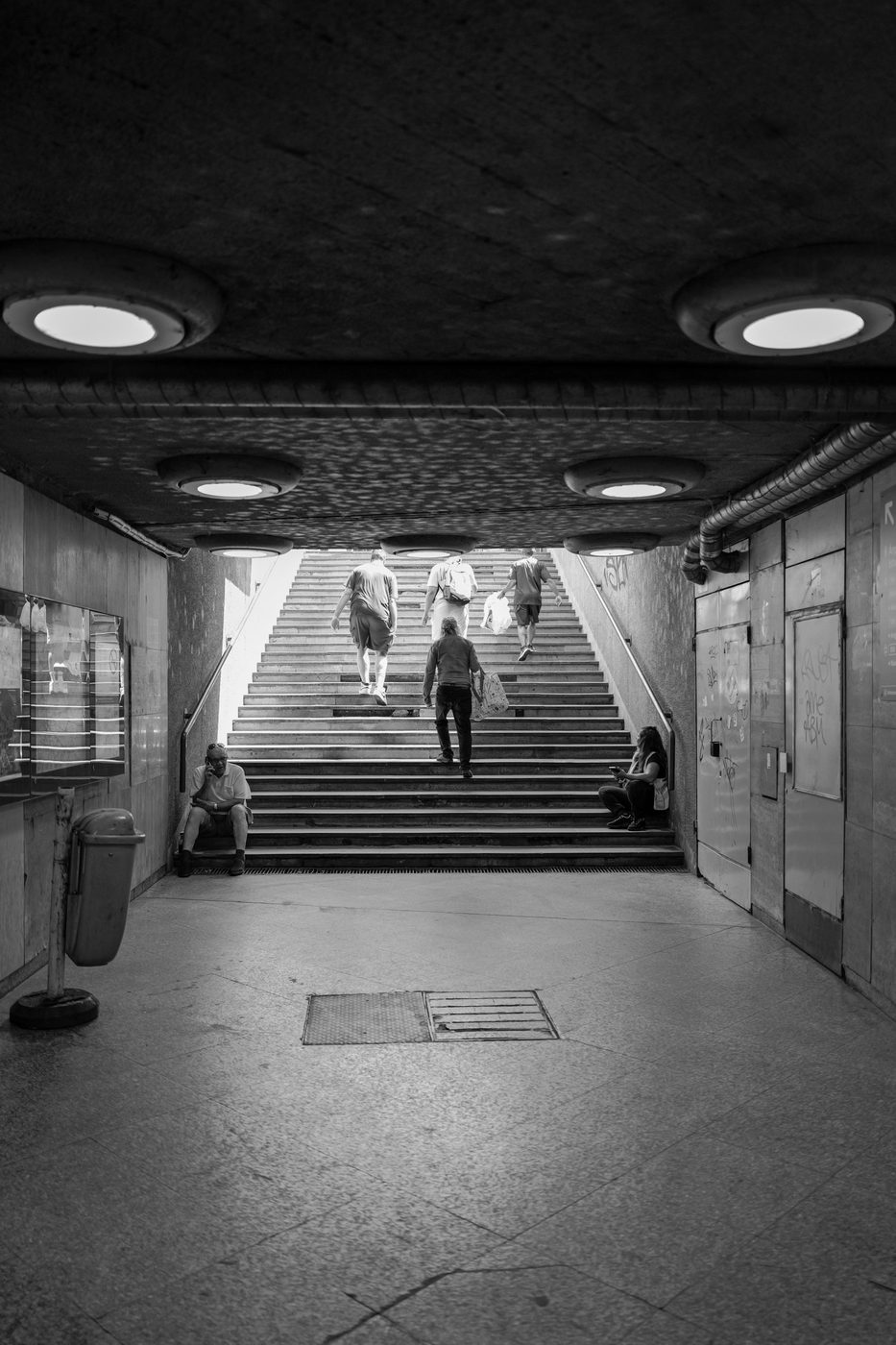 Passers-by climbing stairs toward the exit of an underpass, Budapest