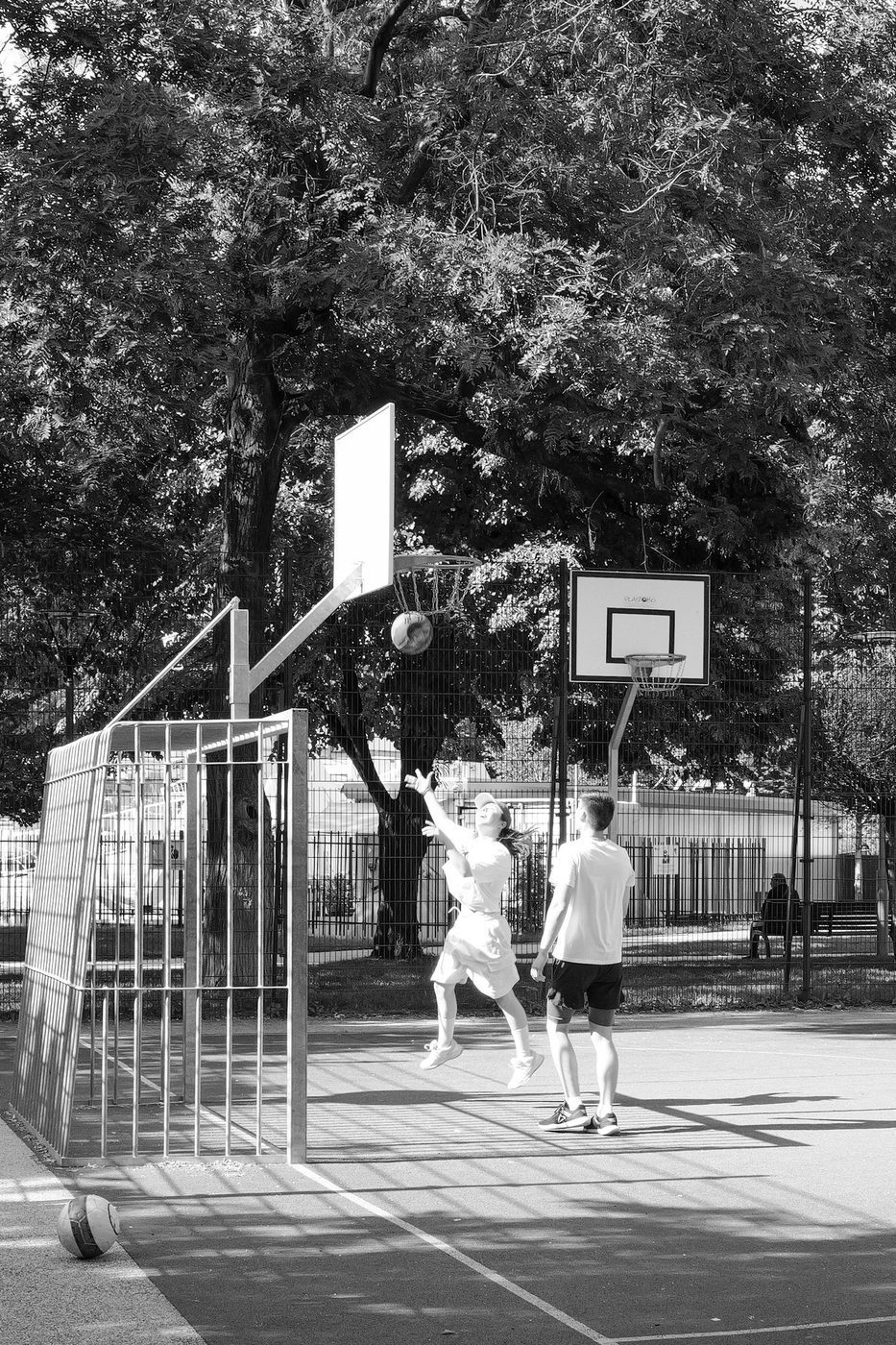 A player suspended in mid-air scoring a basketball basket, Budapest
