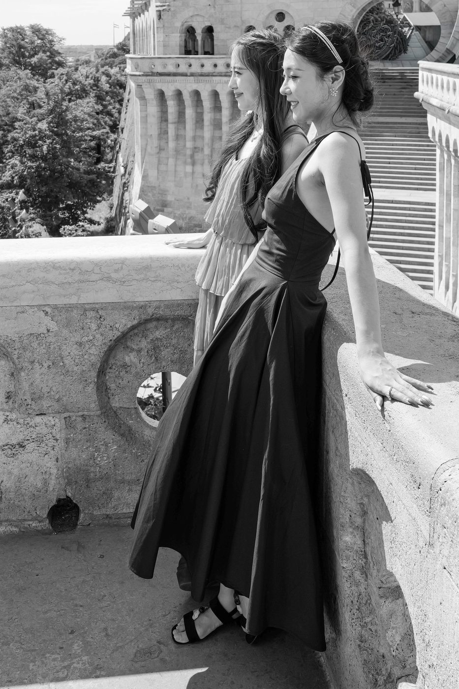 Two friends in evening dresses admiring the view from a terrace, Budapest