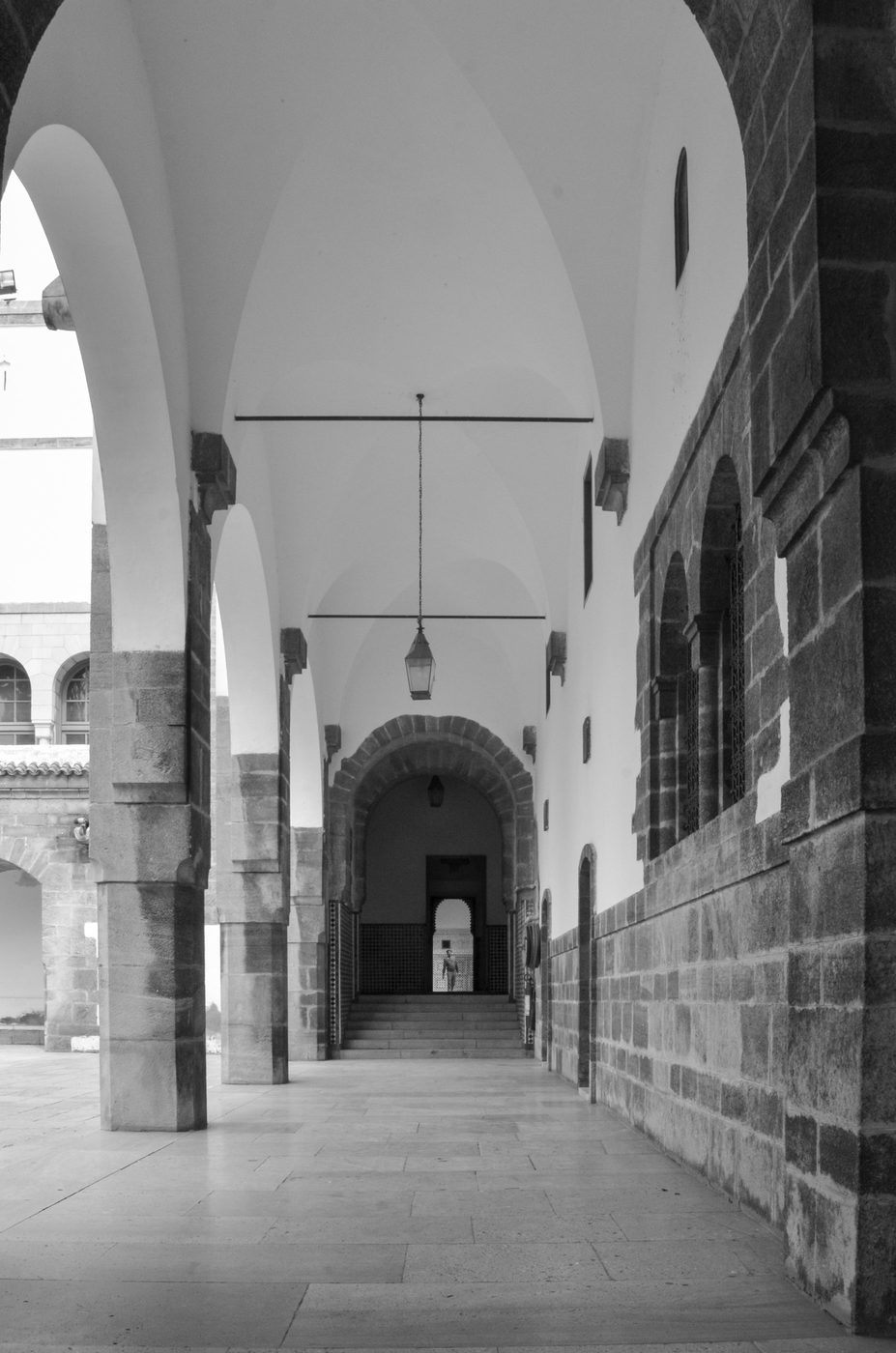 Vaulted gallery with a hanging lantern and a distant silhouette, Casablanca