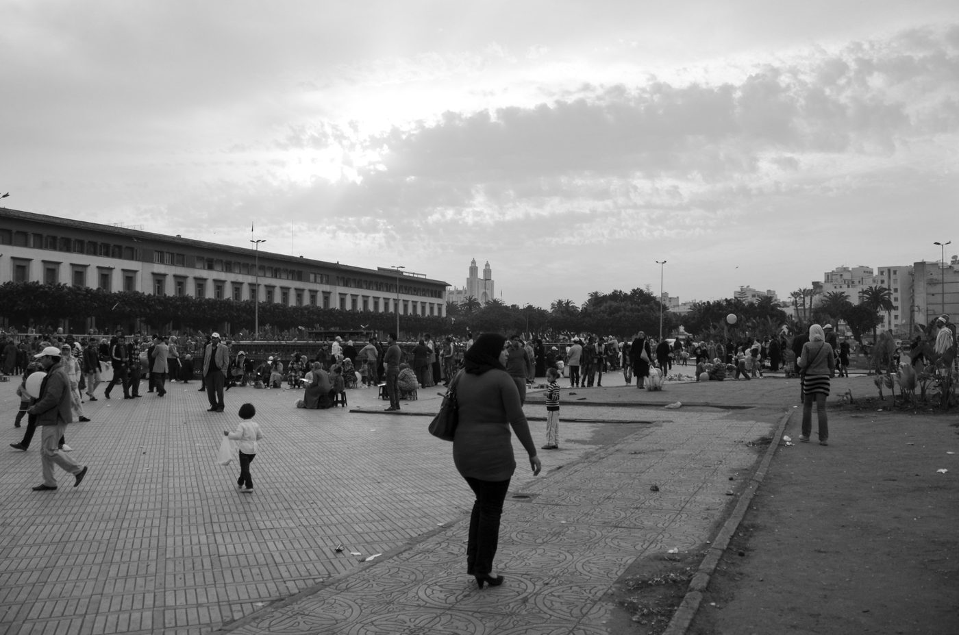 Woman crossing a busy square at the end of the day, Casablanca