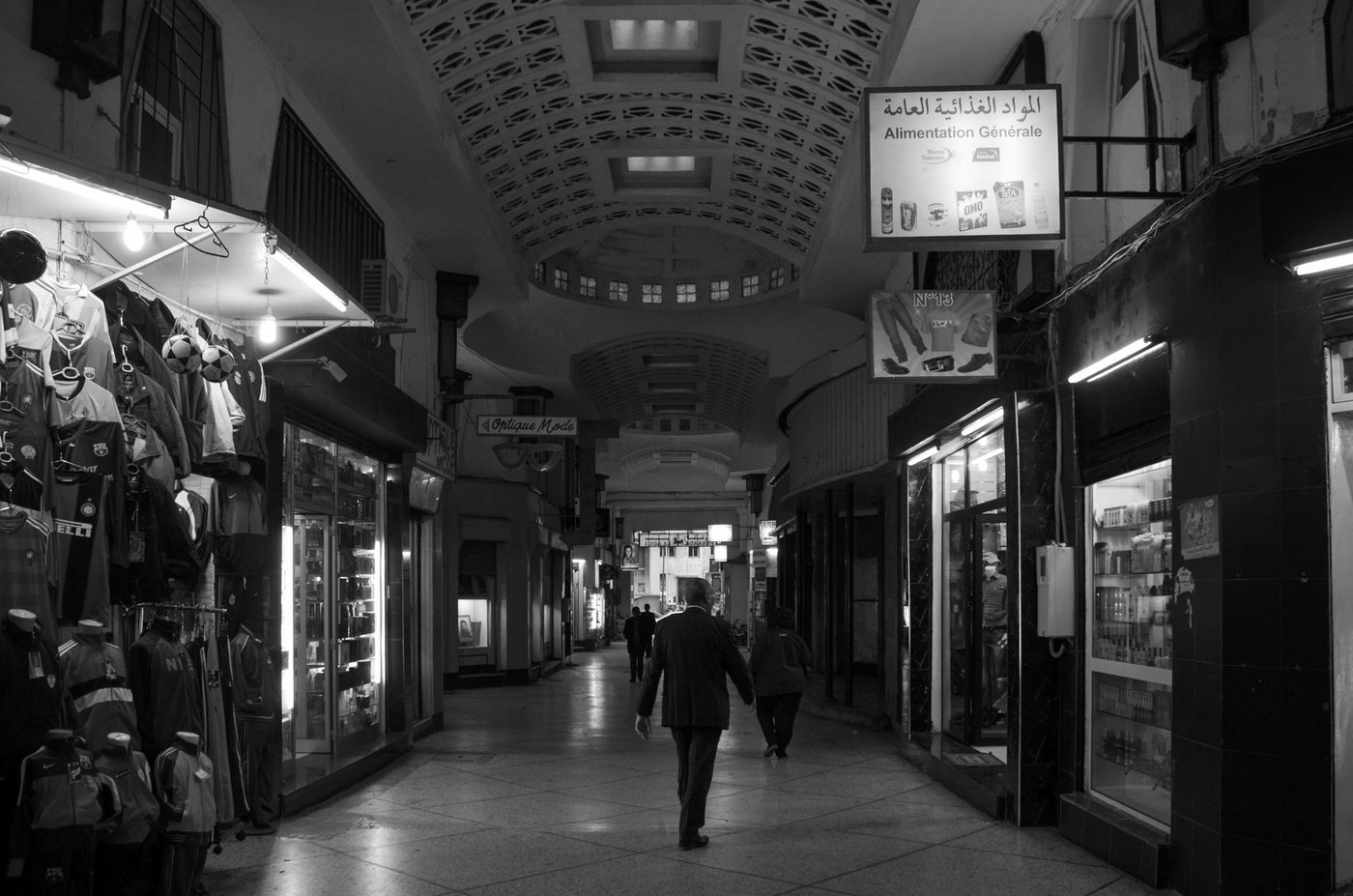 Man in a suit crossing a vaulted shopping arcade, Casablanca