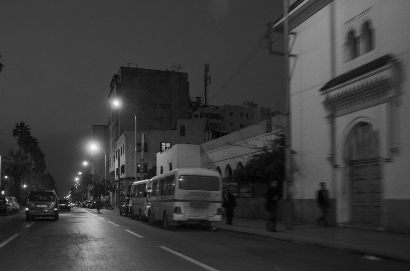 Minibus parked on a night street blurred by motion, Casablanca