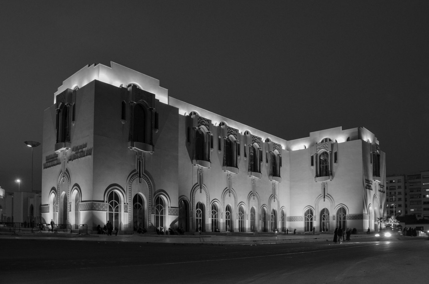 Illuminated facade with ornate arches on a building at night, Casablanca