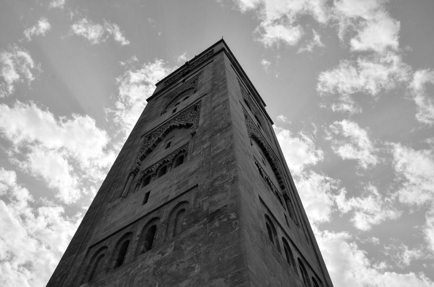 Slender minaret pierced with bay windows under a cloudy sky, Casablanca