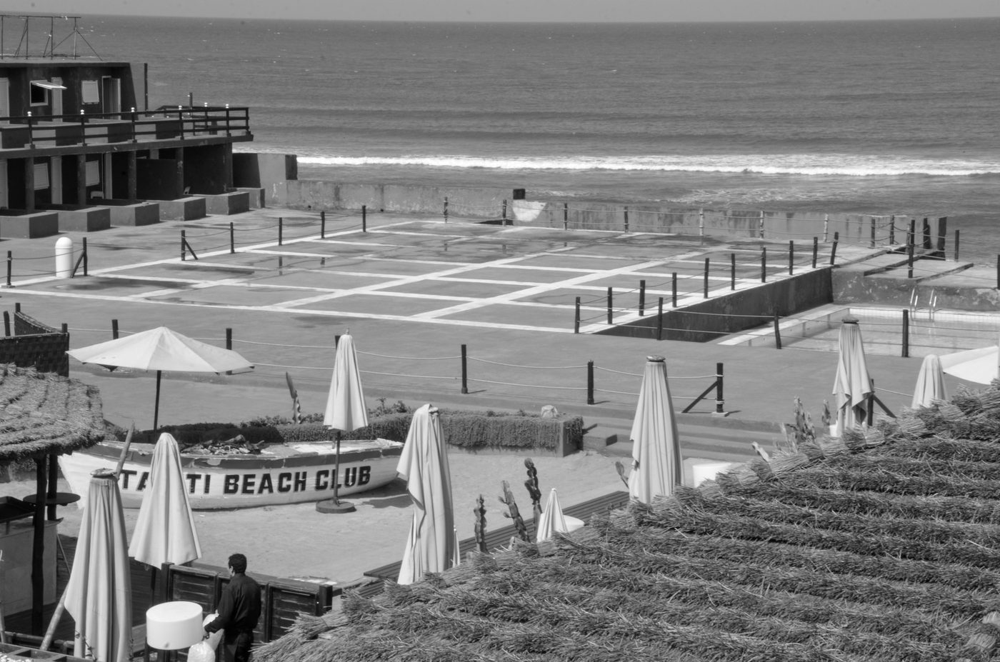 Empty pool and closed parasols by the Atlantic, Casablanca